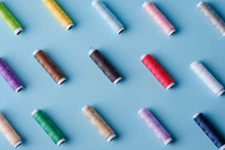 Thread tube colorful on blue background,samless object concept.top viewの写真素材