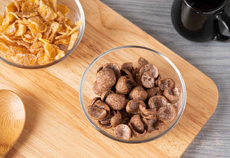 Cereals breakfast cocoa flavor in bowl on wooden boardの写真素材