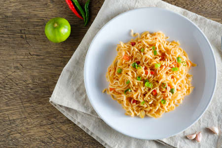A cup of instant noodles placed on a napery With chilli as ingredients top view noodle and copy spaceの写真素材