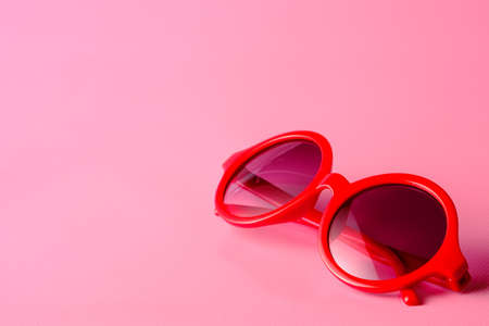 Red glasses on pink  background with copy spaceの写真素材