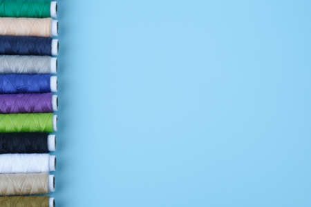 Thread tube colorful on blue background top view and copy spaceの写真素材