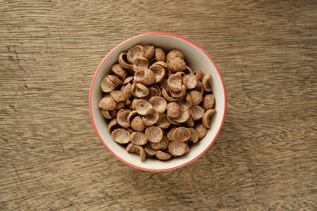 Cereals breakfast in bowl on wooden backdrop top viewの写真素材