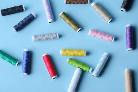 Thread tube colorful on blue background, object concept. top viewの写真素材
