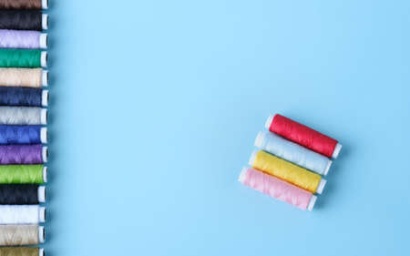 Thread tube colorful on blue background top view and copy spaceの写真素材