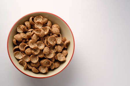 Cereals breakfast cocoa flavor in bowl on wooden backdrop with copy space,top viewの写真素材