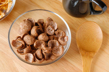 Cereals breakfast cocoa flavor in bowl on wooden board