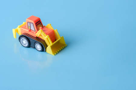 Tractor toy on blue background and copy spaceの写真素材