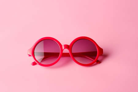 Red glasses on pink  background with copy spaceの写真素材