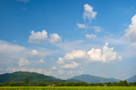 The white clouds have a strange shape and mountainの写真素材