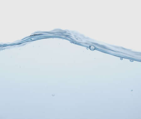 Water splash with bubbles of air and waveの写真素材
