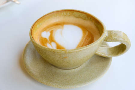Latte art in cup on white backdrop ,copy space and top viewの写真素材