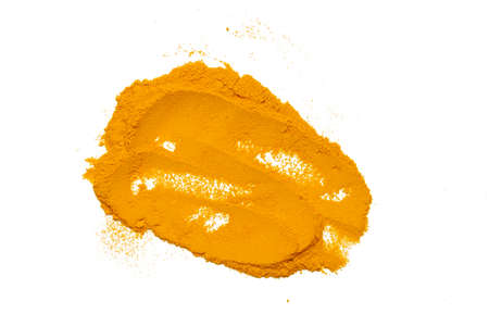 Dry turmeric powder isolated on whiteの写真素材