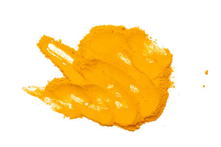 Dry turmeric powder isolated on whiteの写真素材