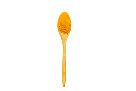 Dry turmeric powder and wooden spoon on  isolated white background.Close-up of powder orange color turmeric.top viewの写真素材