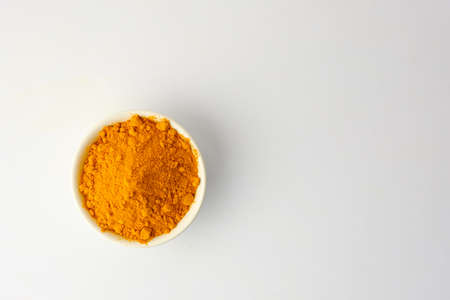 Dry turmeric powder isolated on white background.Close-up of powder orange color turmeric.top view and copy spaceの写真素材