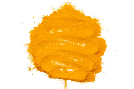 Dry turmeric powder isolated on white background.Close-up of powder orange color turmeric.top viewの写真素材