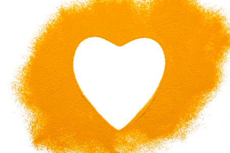 Heart turmeric powder isolated on white background.Close-up of powder orange color turmeric.top view