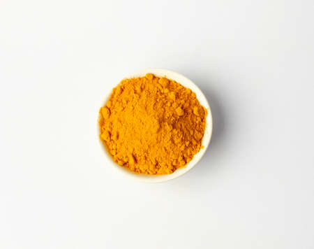 Dry turmeric powder isolated on white background.Close-up of powder orange color turmeric.top viewの写真素材