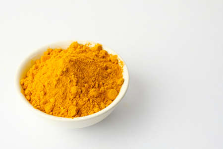 Dry turmeric powder isolated on white background.Close-up of powder orange color turmeric.top viewの写真素材