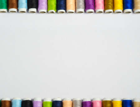 Thread on white background top view with copy space