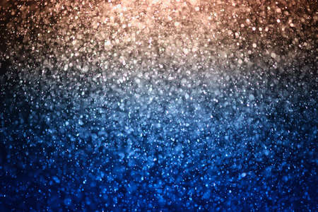 glitter bokeh of light background .Abstract blurred light.blue and gold colorの写真素材