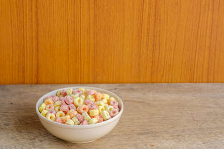 Cereal flakes in bowl with copy space,Breakfast concept.Food with delicious fruity taste and fruity...
