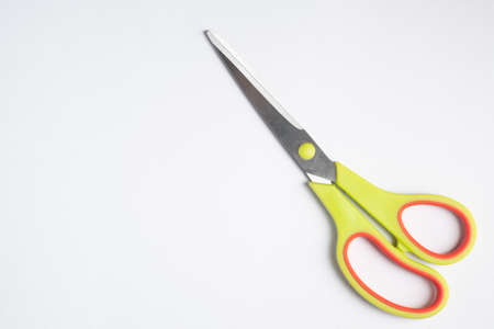 Scissors on white backdrop and copy space .Plastic handle scissors