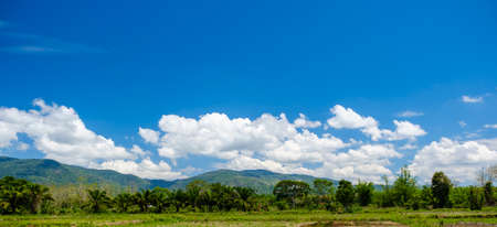 The white clouds have a strange shape and moutain.The sky and the open space have mountains below.Clouds floating above the mountains.の写真素材