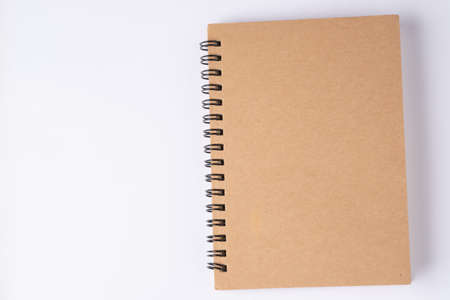 Brown notebook on white background.The cover is made of cardboard, covered with recycled paper, which is durable and environmentally friendly.Suitable for writing or taking notes.の写真素材