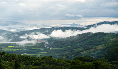 The white clouds have a strange shape and moutain.The sky and the open space have mountains below.Clouds floating above the mountains.の写真素材