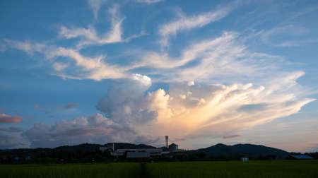 Colorful sunset and sunrise with clouds.Blue and orange color of nature.Many white clouds in the blue sky.The weather is clear today.sunset in the clouds.The sky is twilight.の写真素材