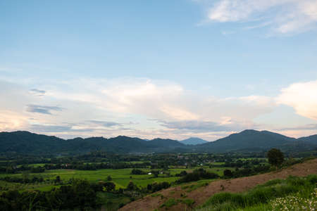 The white clouds have a strange shape and moutain.The sky and the open space have mountains below.Clouds floating above the mountains.の写真素材