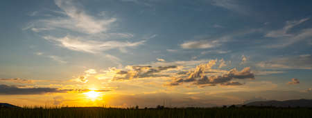 Colorful sunset and sunrise with clouds.Blue and orange color of nature.Many white clouds in the blue sky.The weather is clear today.sunset in the clouds.The sky is twilight.の写真素材