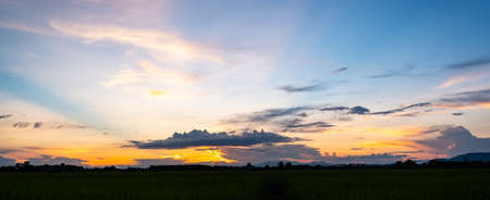 Colorful sunset and sunrise with clouds.Blue and orange color of nature.Many white clouds in the blue sky.The weather is clear today.sunset in the clouds.The sky is twilight.の写真素材