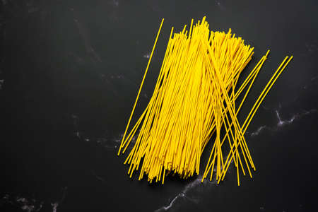 Selective focus yellow noodles in dish.food and copy space.raw pasta.Rice vermicelli and space.の写真素材