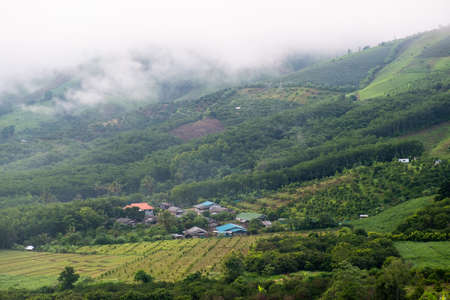 The village in the middle of the mountains around there are farms.Farming on the mountainの写真素材