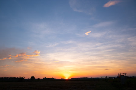 Colorful sunset and sunrise with clouds.Blue and orange color of nature.Many white clouds in the blue sky.The weather is clear today.sunset in the clouds.The sky is twilight.の写真素材