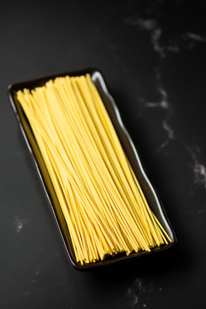 Selective focus yellow noodles in dish.food and copy space.raw pasta.Rice vermicelli and space.の写真素材