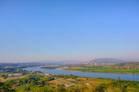The sky has clouds and the Mekong River.sky and cloud.white clouds.Village near the river.Border river.River border Thailand and Laosの写真素材