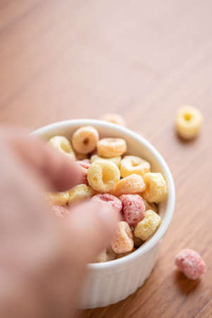 Cereal flakes in bowl ceramic with copy space,Breakfast concept.Food with delicious fruity taste and fruity colours.It's made with maize,wheat,and barleyの写真素材
