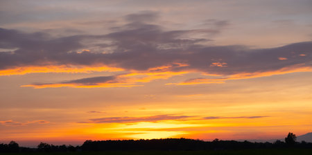 Colorful sunset and sunrise with clouds.Blue and orange color of nature.Many white clouds in the blue sky.The weather is clear today.sunset in the clouds.The sky is twilight.の写真素材