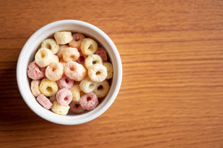 Cereal flakes in bowl ceramic with copy space,Breakfast concept.Food with delicious fruity taste and fruity colours.It's made with maize,wheat,and barleyの写真素材