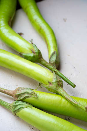 Close up and selective focus green eggplant.Eggplant on white backdrop.Vegetable on tableの写真素材