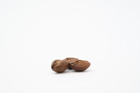 Bean coffee in isolated white background. Medium roasted coffee beans are light brown in color in white backgroundの写真素材