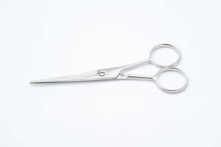 Silver scissors on white background.Paper cutting tool.Items for cutting hair on white backgroundの写真素材