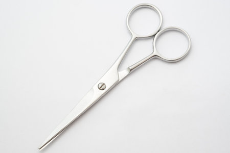Silver scissors on white background.Paper cutting tool.Items for cutting hair on white backgroundの写真素材