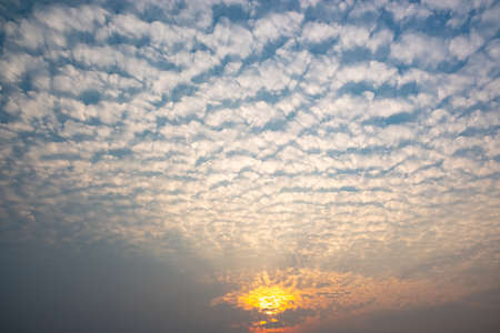 White cloudy with a blue  sky.Wave clouds on the sky.Fluffy cloud and sunsetの写真素材