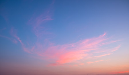 Colorful sunset and sunrise with clouds. Blue and orange color of nature. Many white clouds in the blue sky. The weather is clear today. sunset in the clouds. The sky is twilightの写真素材