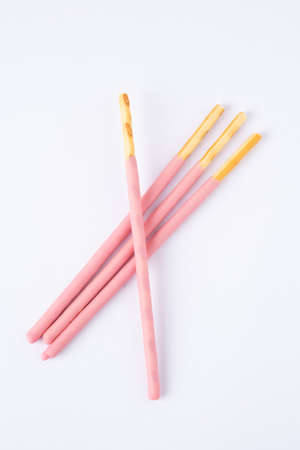 Strawberry flavor biscuit stick on white background. Pink biscuit stickの写真素材