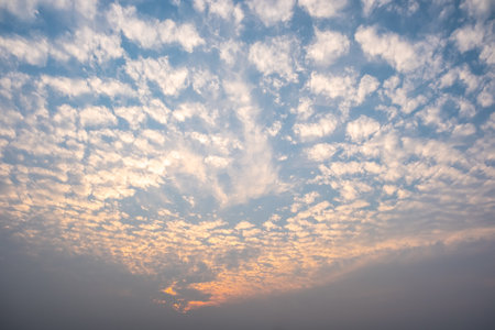 White cloudy with a blue  sky.Wave clouds on the sky.Fluffy cloud and sunsetの写真素材